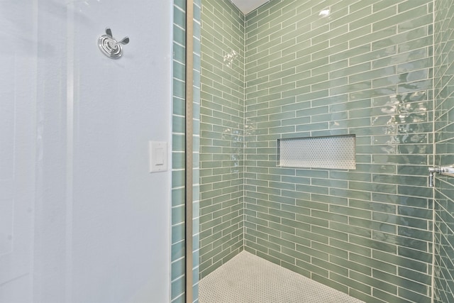 bathroom with a tile shower