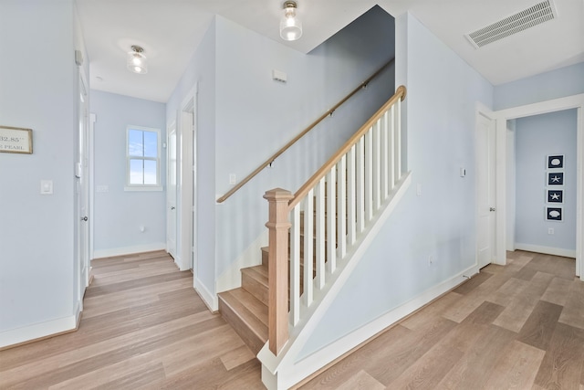 stairs featuring hardwood / wood-style flooring