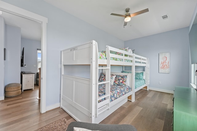 bedroom with hardwood / wood-style floors and ceiling fan