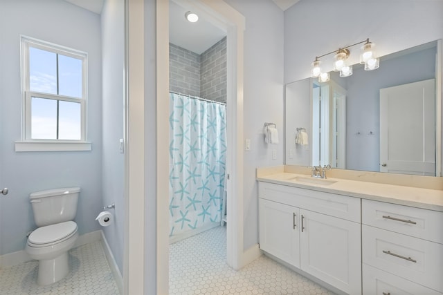 bathroom with toilet, walk in shower, vanity, and tile patterned flooring