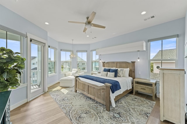 bedroom featuring light hardwood / wood-style flooring, access to exterior, and ceiling fan