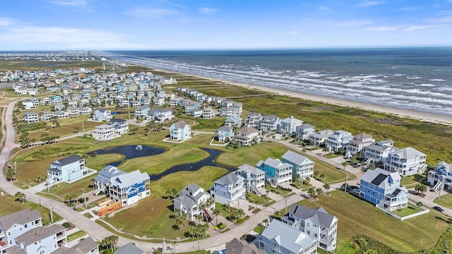 bird's eye view featuring a water view and a beach view