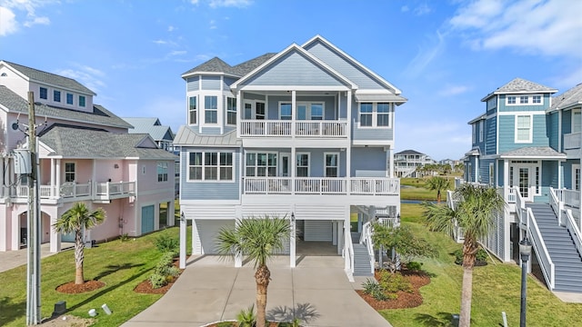 view of front facade with a front yard, a carport, and a balcony