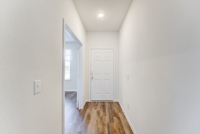 corridor with dark hardwood / wood-style floors