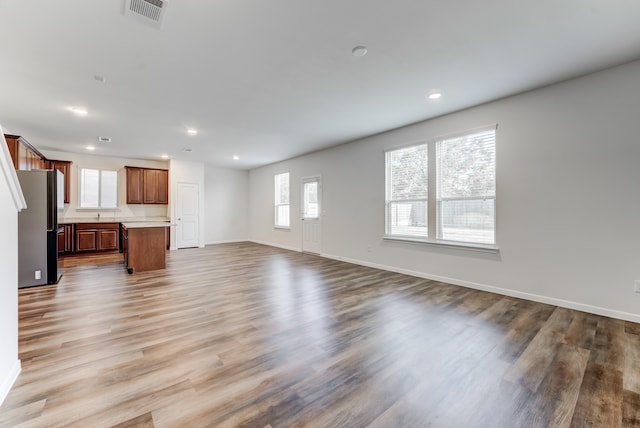 unfurnished living room with light wood-type flooring