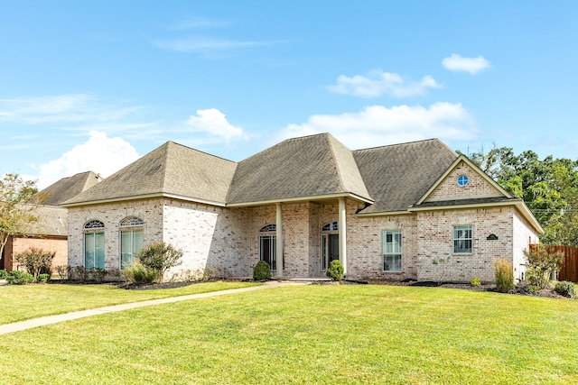 french country inspired facade featuring a front yard