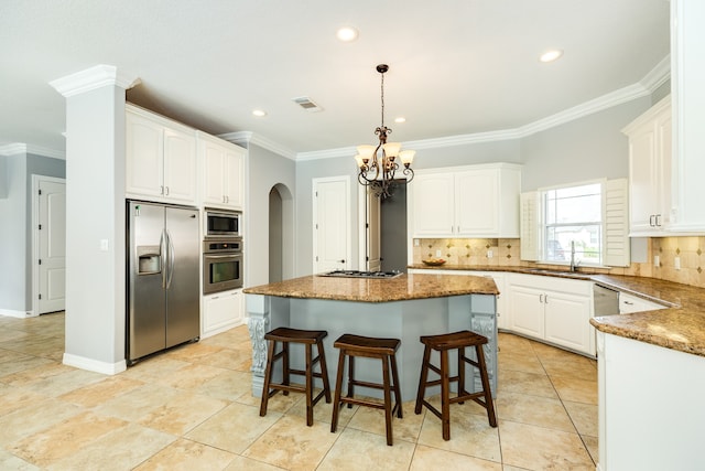 kitchen featuring sink, a kitchen island, appliances with stainless steel finishes, and white cabinetry