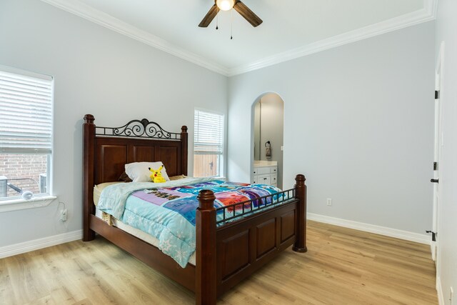 bedroom with ceiling fan, crown molding, multiple windows, and light hardwood / wood-style floors