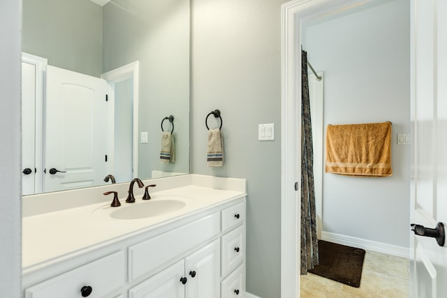 bathroom with vanity, walk in shower, and tile patterned flooring