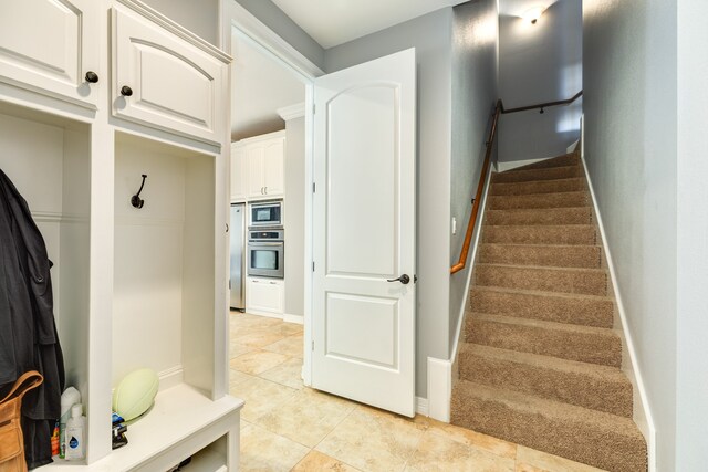 stairs featuring tile patterned floors