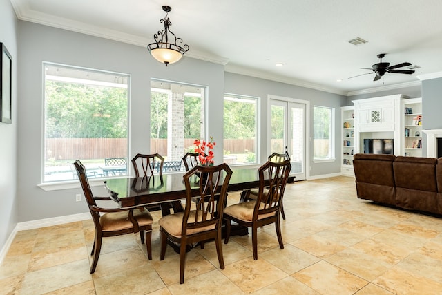 dining area with crown molding, plenty of natural light, and ceiling fan