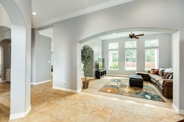 living room with crown molding, light hardwood / wood-style floors, and ceiling fan