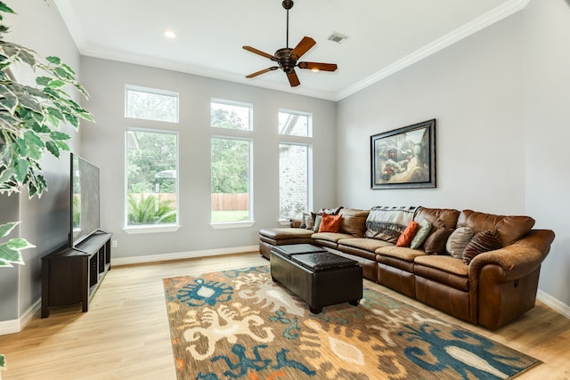 living room with crown molding, light hardwood / wood-style floors, and ceiling fan