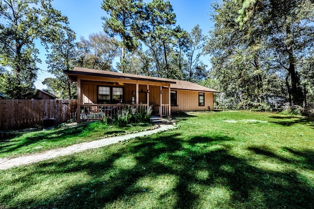 back of property featuring a yard and ceiling fan