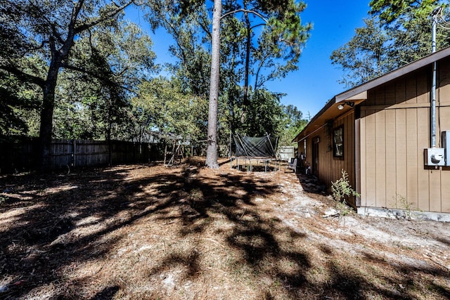 12 Dove St, New Waverly, TX 77358 - view of yard with a trampoline and fence
