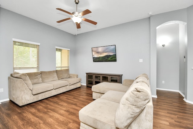 living room with dark hardwood / wood-style floors and ceiling fan