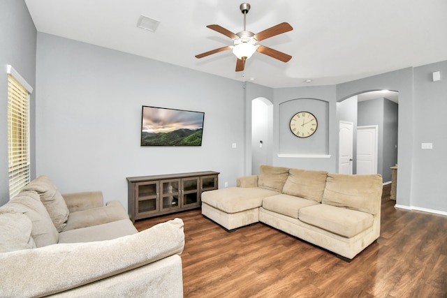 living room featuring ceiling fan and dark hardwood / wood-style floors