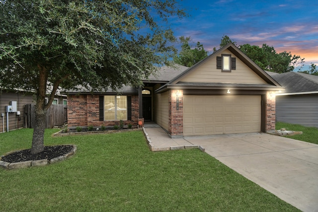 single story home featuring a garage and a lawn