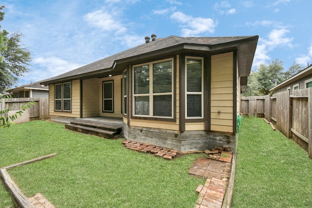 rear view of house with a yard