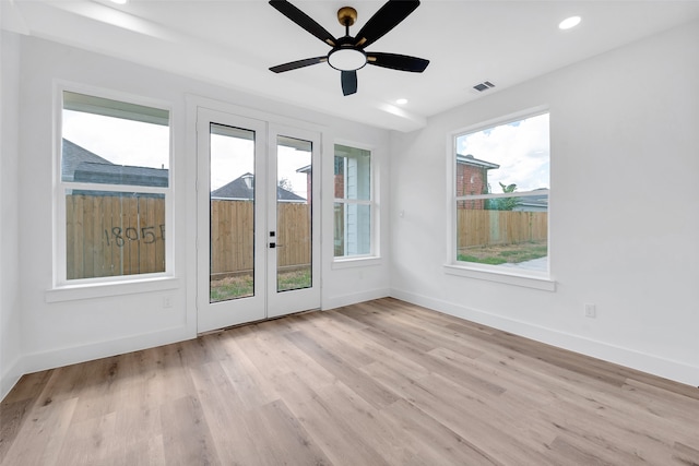 interior space with baseboards, french doors, and light wood-style floors