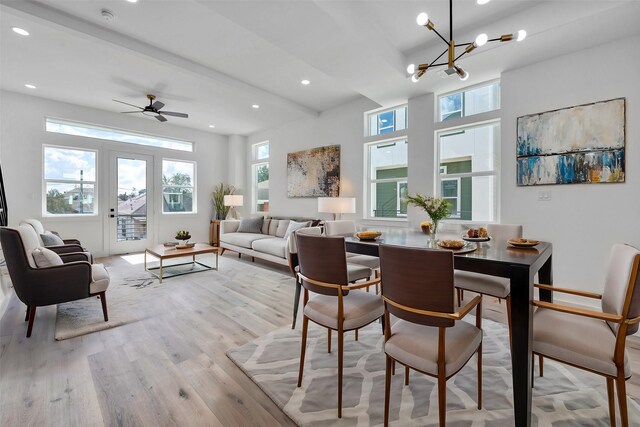 dining area with recessed lighting, light wood finished floors, ceiling fan with notable chandelier, and beam ceiling