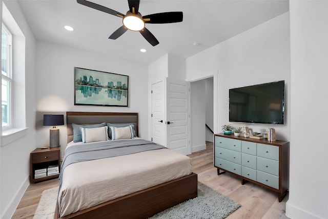 bedroom with baseboards, a ceiling fan, light wood-style flooring, and recessed lighting