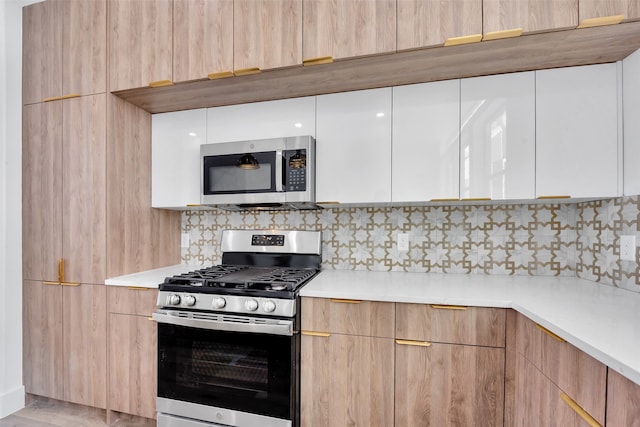 kitchen with light countertops, modern cabinets, and stainless steel appliances