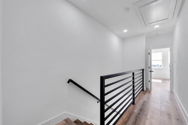 staircase with baseboards, attic access, recessed lighting, and wood finished floors