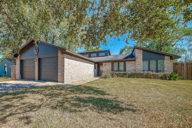 view of front of house with a front yard and a garage