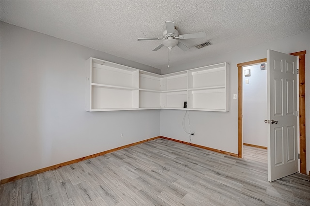 unfurnished room featuring ceiling fan, a textured ceiling, and light hardwood / wood-style flooring