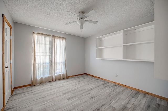 spare room featuring a textured ceiling, light hardwood / wood-style floors, and ceiling fan