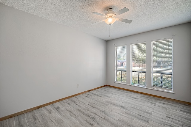 spare room featuring ceiling fan, light hardwood / wood-style floors, and a textured ceiling