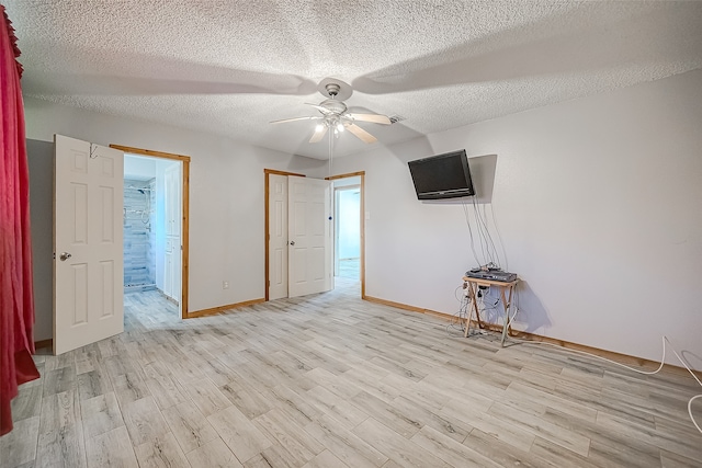 interior space with ceiling fan, a textured ceiling, and light hardwood / wood-style flooring