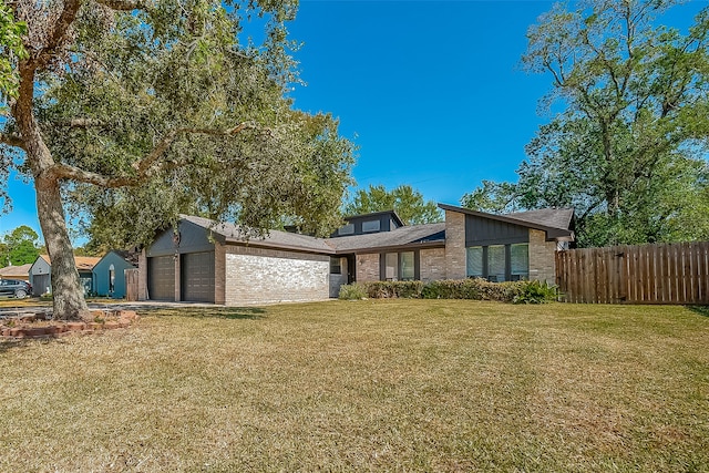 view of front facade with a front yard and a garage