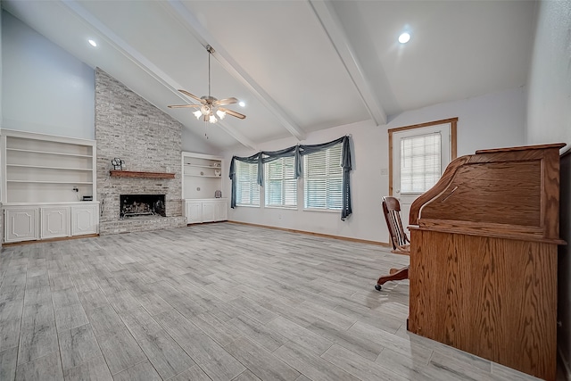 office space with high vaulted ceiling, ceiling fan, built in features, a fireplace, and beam ceiling