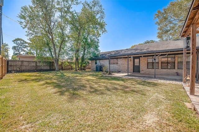 view of yard featuring central AC and a patio area