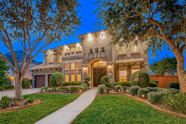 view of front of house with a front yard, a balcony, and a garage