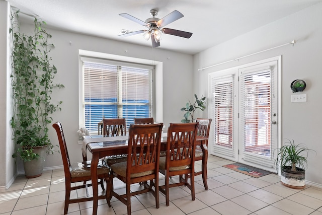 tiled dining space with ceiling fan