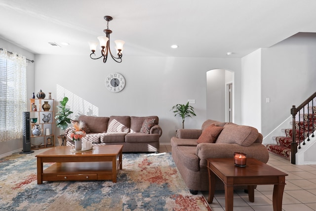 tiled living room featuring a notable chandelier