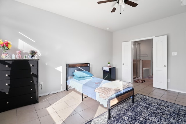 tiled bedroom with lofted ceiling, ensuite bathroom, and ceiling fan