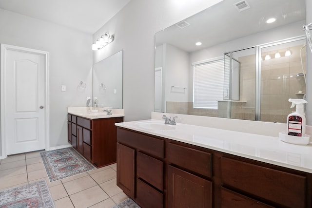 bathroom with vanity, walk in shower, and tile patterned flooring