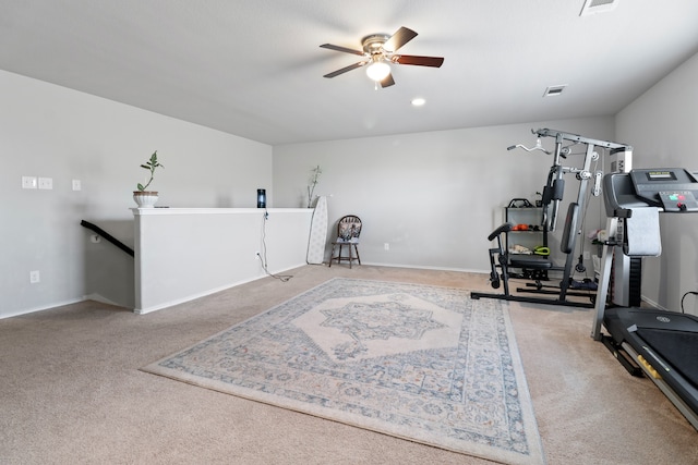 exercise room with light carpet and ceiling fan