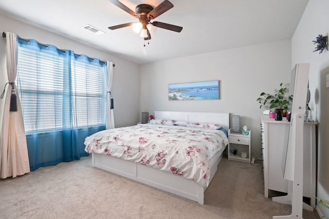 bedroom with light carpet and ceiling fan