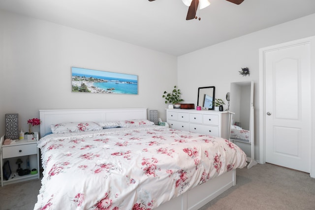 bedroom with ceiling fan and light carpet