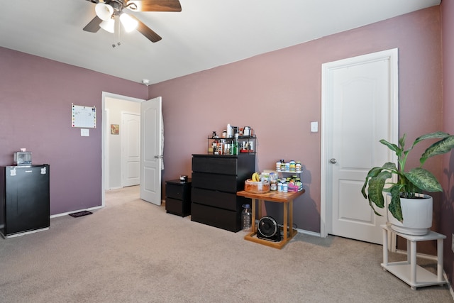 miscellaneous room featuring light carpet and ceiling fan