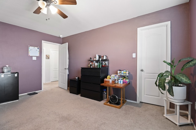 misc room with ceiling fan and light colored carpet