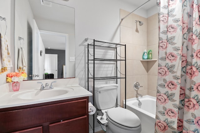 full bathroom featuring vanity, shower / bath combo with shower curtain, and toilet