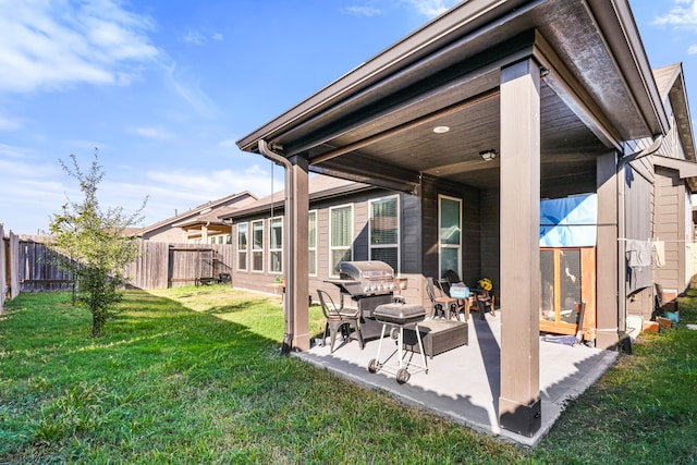 back of property with a patio and a lawn