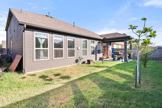 back of house featuring a yard and a patio