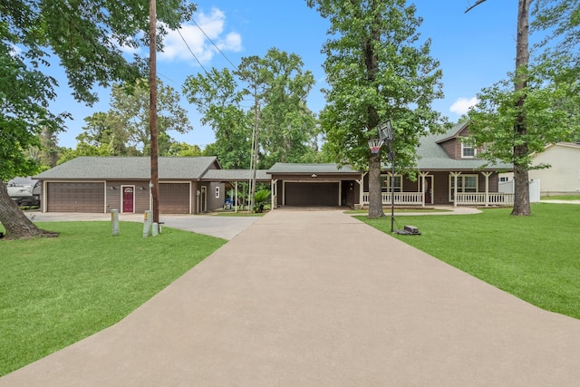 view of front facade featuring a front yard, a porch, and a garage